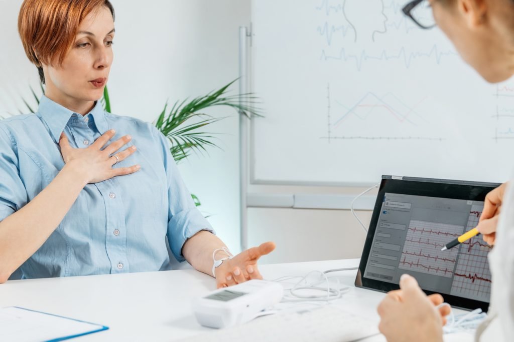 Biofeedback breathing training session at a health center. Therapist monitoring breathing pattern of a client.